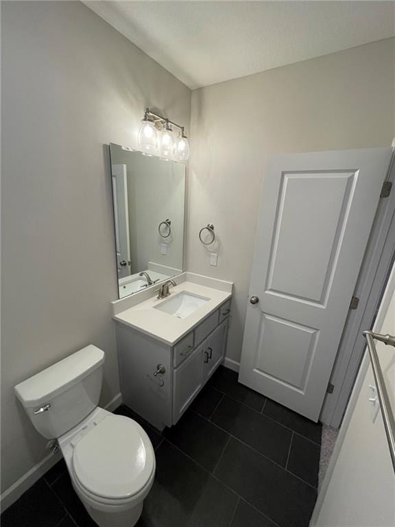 10617 N Fisk Ave, Kansas City, MO 64154 - bathroom featuring tile patterned floors, vanity, toilet, and baseboards