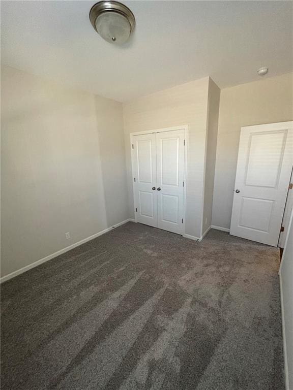 10617 N Fisk Ave, Kansas City, MO 64154 - unfurnished bedroom with baseboards, carpet flooring, and a closet
