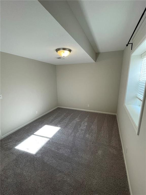 10617 N Fisk Ave, Kansas City, MO 64154 - empty room with dark colored carpet and baseboards