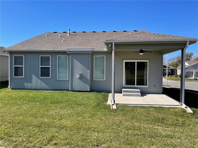 10617 N Fisk Ave, Kansas City, MO 64154 - back of house with ceiling fan, a patio, roof with shingles, and a lawn