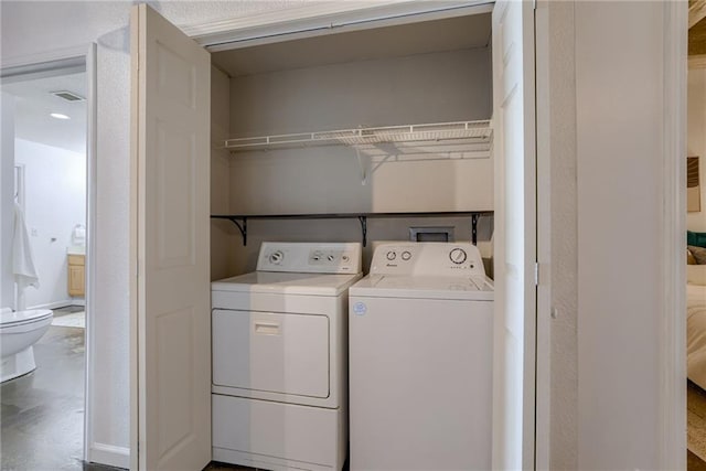 clothes washing area with washer and dryer