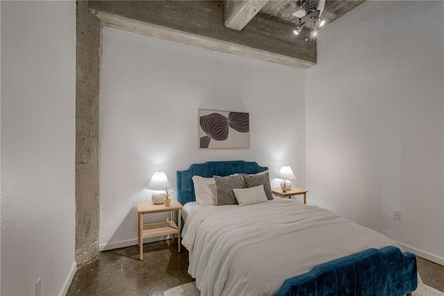 bedroom featuring baseboards and concrete floors