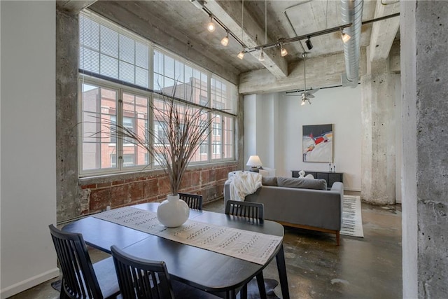 dining room with concrete floors and track lighting