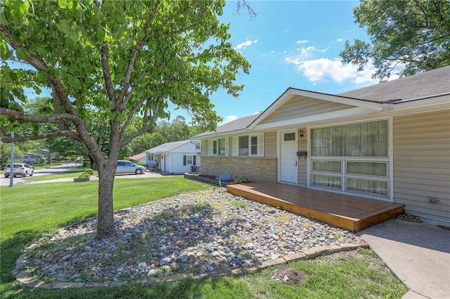 11205 E 49th St, Kansas City, MO 64133 - view of front of home featuring a front lawn and stone siding