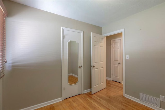 11205 E 49th St, Kansas City, MO 64133 - unfurnished bedroom with light wood-style floors and baseboards