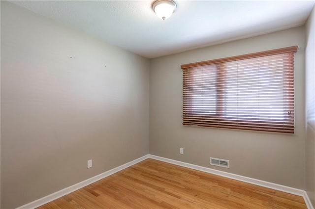 11205 E 49th St, Kansas City, MO 64133 - unfurnished room with baseboards and light wood-style floors