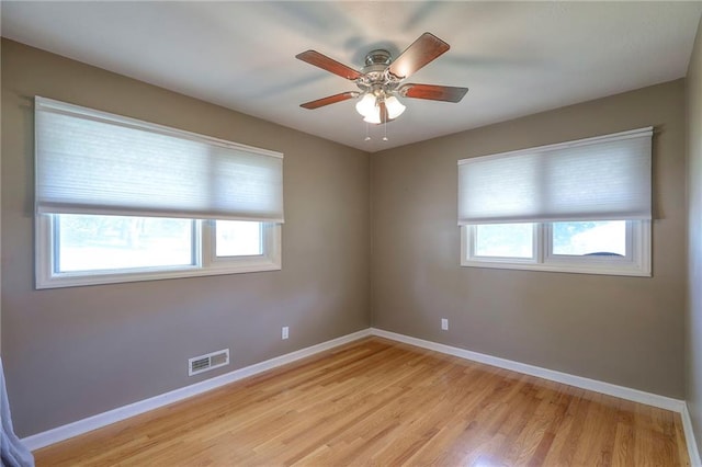 11205 E 49th St, Kansas City, MO 64133 - unfurnished room featuring baseboards, light wood-style flooring, and a ceiling fan