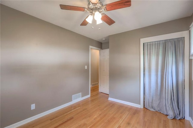11205 E 49th St, Kansas City, MO 64133 - unfurnished bedroom with baseboards, light wood finished floors, and ceiling fan