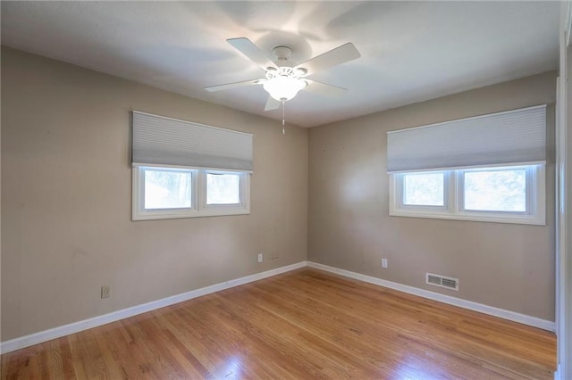 11205 E 49th St, Kansas City, MO 64133 - spare room featuring healthy amount of natural light, light wood finished floors, baseboards, and ceiling fan