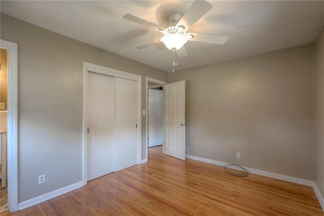 11205 E 49th St, Kansas City, MO 64133 - unfurnished bedroom featuring baseboards, light wood finished floors, a closet, and ceiling fan
