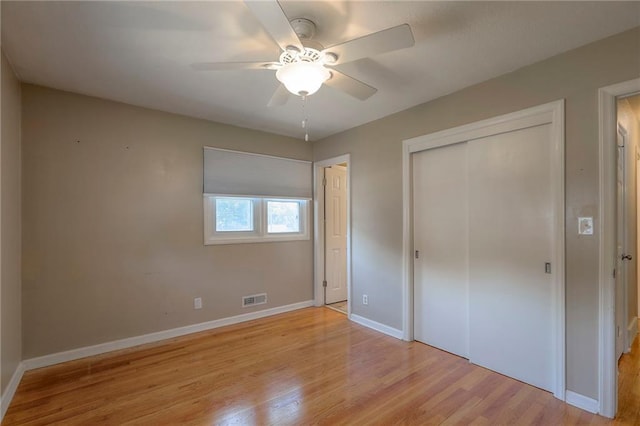 11205 E 49th St, Kansas City, MO 64133 - unfurnished bedroom with light wood finished floors, baseboards, a closet, and ceiling fan