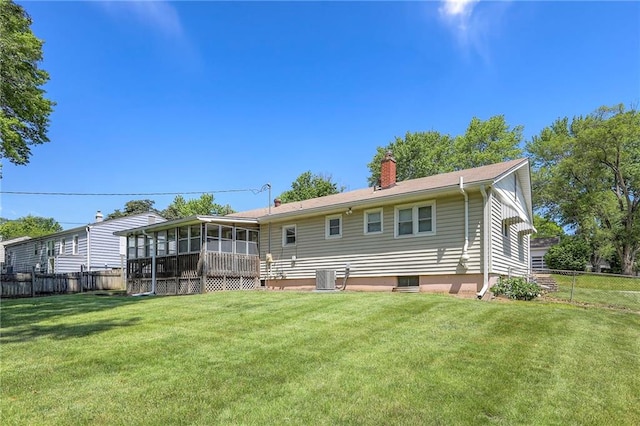 11205 E 49th St, Kansas City, MO 64133 - back of property with a sunroom, central air condition unit, and a chimney