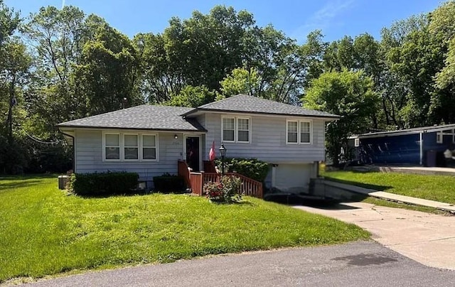 2930 N 64th Ter, Kansas City, KS 66104 - tri-level home featuring concrete driveway, a front lawn, and a garage