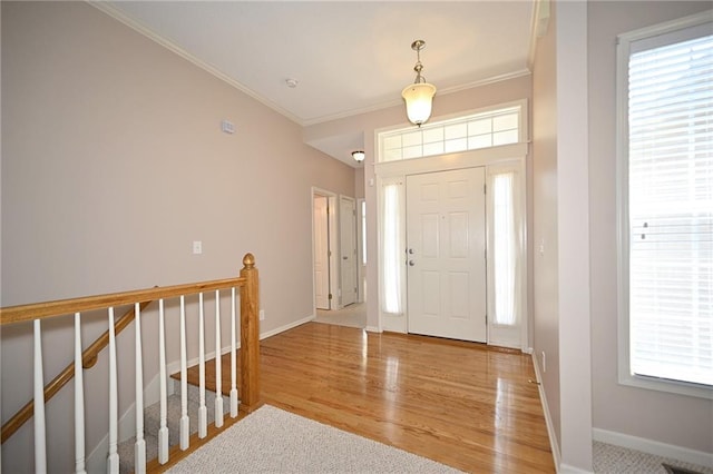 3112 NW 86th St, Kansas City, MO 64154 - foyer entrance with crown molding, baseboards, and wood finished floors
