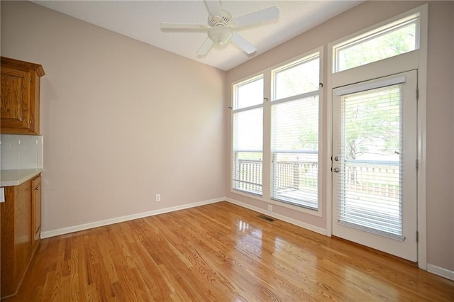 3112 NW 86th St, Kansas City, MO 64154 - unfurnished dining area featuring light wood-type flooring, baseboards, and a ceiling fan