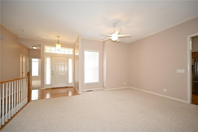 3112 NW 86th St, Kansas City, MO 64154 - entryway with light carpet, a ceiling fan, crown molding, and baseboards