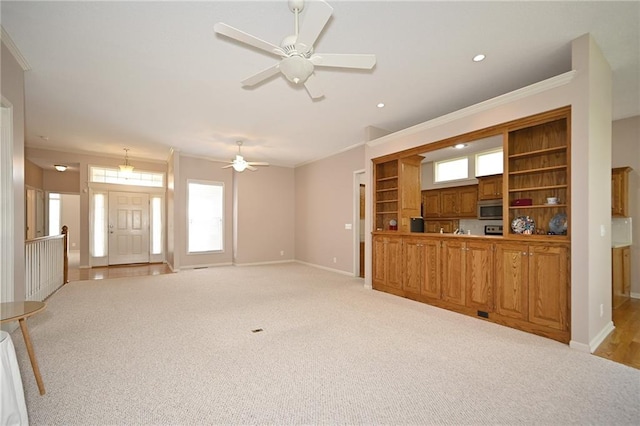 3112 NW 86th St, Kansas City, MO 64154 - unfurnished living room featuring baseboards, ornamental molding, light colored carpet, a ceiling fan, and recessed lighting