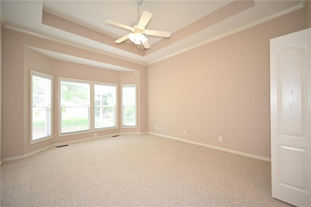 3112 NW 86th St, Kansas City, MO 64154 - empty room with a tray ceiling, crown molding, carpet floors, baseboards, and ceiling fan