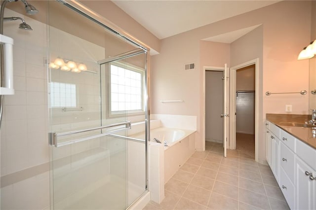 3112 NW 86th St, Kansas City, MO 64154 - full bathroom featuring a stall shower, a bath, tile patterned floors, vanity, and a spacious closet