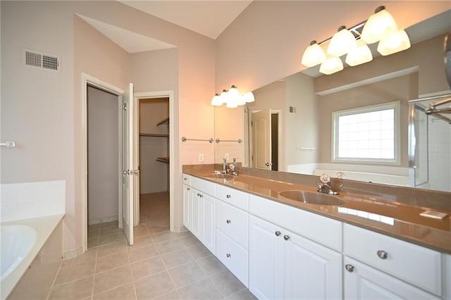 3112 NW 86th St, Kansas City, MO 64154 - full bath with tile patterned flooring, a bath, double vanity, and a walk in closet