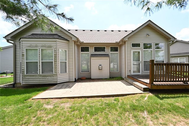 3112 NW 86th St, Kansas City, MO 64154 - back of property featuring a wooden deck, a shingled roof, a yard, and a patio area