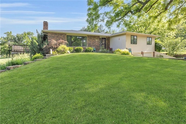 1758 Labette Rd, Ottawa, KS 66067 - view of front facade featuring a chimney, a front yard, an attached garage, and brick siding