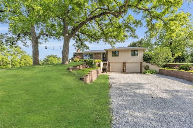 1758 Labette Rd, Ottawa, KS 66067 - view of front of property with driveway, stairs, a garage, brick siding, and a front yard
