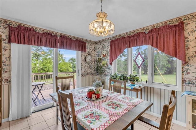 1758 Labette Rd, Ottawa, KS 66067 - dining room featuring wallpapered walls, a chandelier, light tile patterned flooring, and plenty of natural light