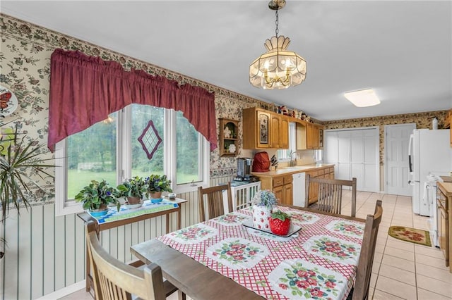 1758 Labette Rd, Ottawa, KS 66067 - dining space with wallpapered walls, a chandelier, and light tile patterned floors