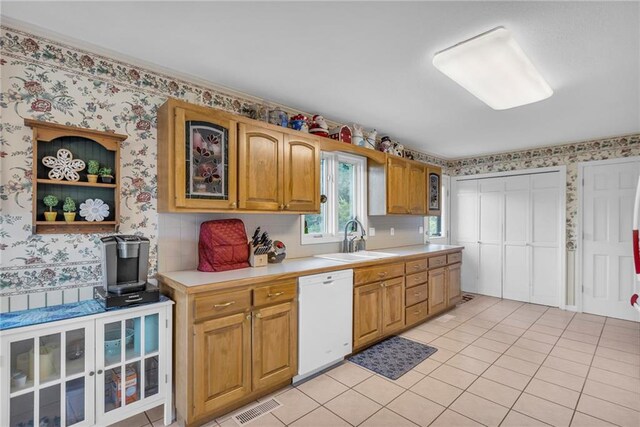 1758 Labette Rd, Ottawa, KS 66067 - kitchen featuring white dishwasher, wallpapered walls, a sink, light countertops, and light tile patterned flooring