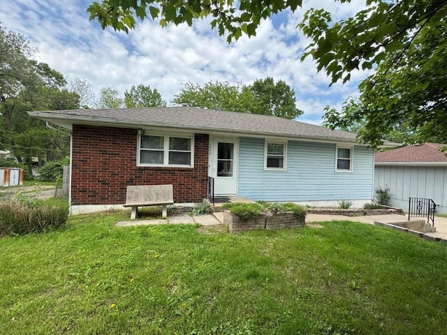 1606 N Ponca Dr, Independence, MO 64058 - rear view of property with a yard and brick siding