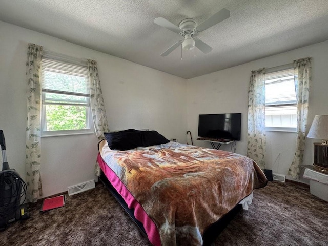 1606 N Ponca Dr, Independence, MO 64058 - bedroom with carpet flooring, multiple windows, ceiling fan, a textured ceiling, and baseboards