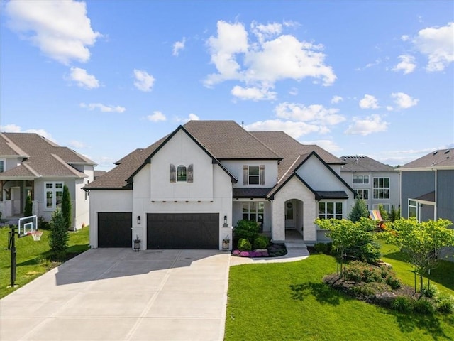 15624 Delmar St, Overland Park, KS 66224 - french country inspired facade featuring stucco siding, driveway, a front lawn, a garage, and roof with shingles