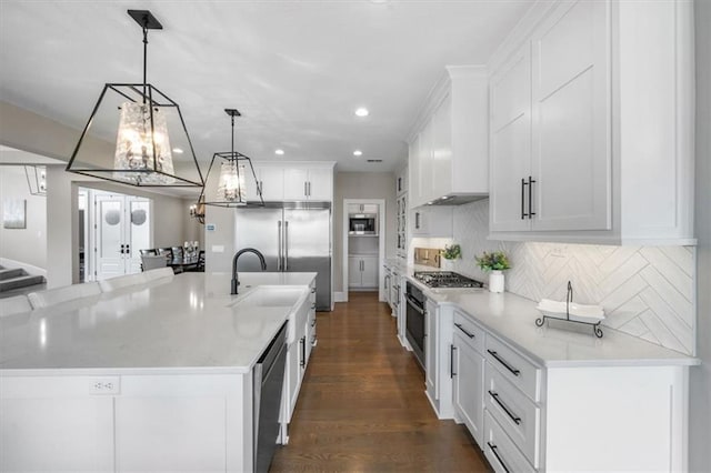 15624 Delmar St, Overland Park, KS 66224 - kitchen featuring stainless steel appliances, recessed lighting, a chandelier, white cabinets, and tasteful backsplash