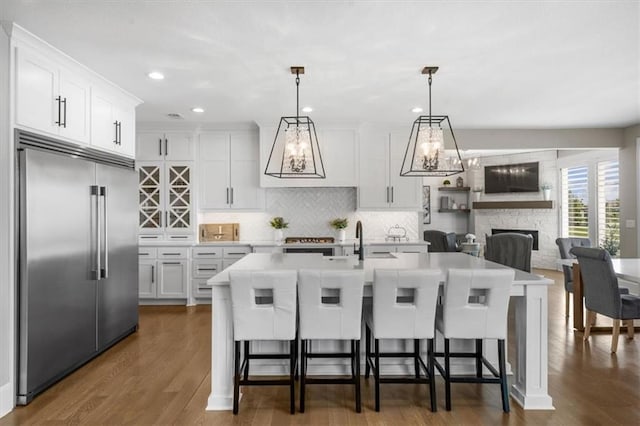 15624 Delmar St, Overland Park, KS 66224 - kitchen featuring stainless steel built in fridge, light countertops, tasteful backsplash, white cabinets, and recessed lighting
