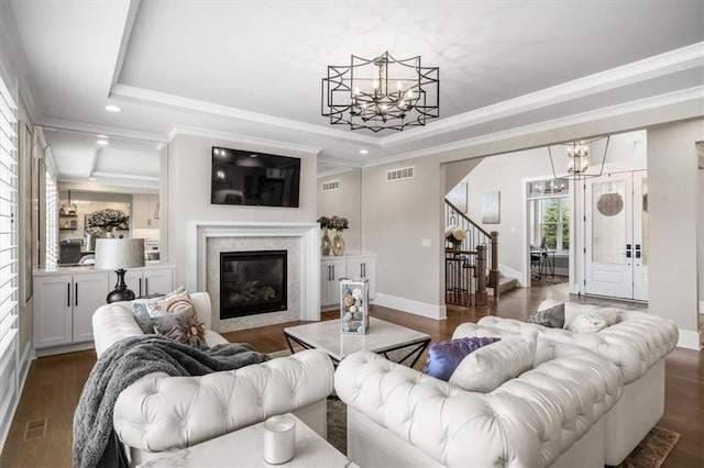15624 Delmar St, Overland Park, KS 66224 - living room with a chandelier, a raised ceiling, stairway, recessed lighting, and crown molding