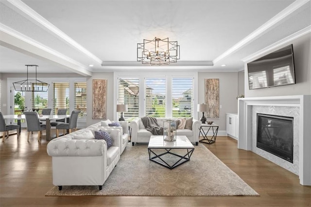 15624 Delmar St, Overland Park, KS 66224 - living area with a chandelier, a raised ceiling, wood finished floors, crown molding, and recessed lighting