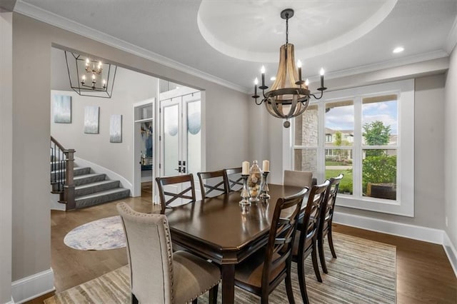 15624 Delmar St, Overland Park, KS 66224 - dining room featuring a chandelier, stairs, baseboards, wood finished floors, and a tray ceiling