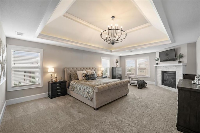 15624 Delmar St, Overland Park, KS 66224 - bedroom with a tray ceiling, light colored carpet, a chandelier, and a fireplace