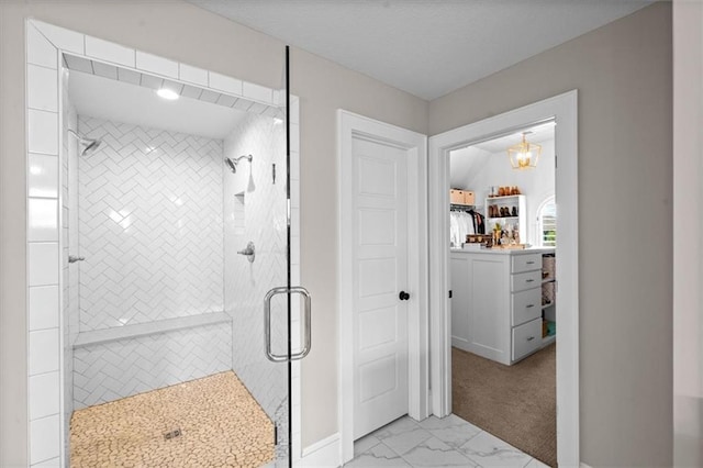 15624 Delmar St, Overland Park, KS 66224 - bathroom with a shower stall, marble look tiles, baseboards, and a chandelier