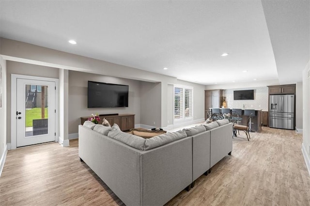 15624 Delmar St, Overland Park, KS 66224 - living room with baseboards, light wood finished floors, and recessed lighting