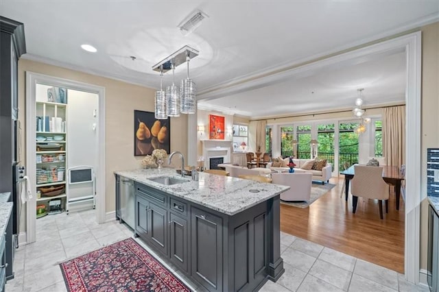 4801 W 133rd St Unit 204, Leawood, KS 66209 - kitchen featuring a sink, ornamental molding, light tile patterned floors, a peninsula, and pendant lighting