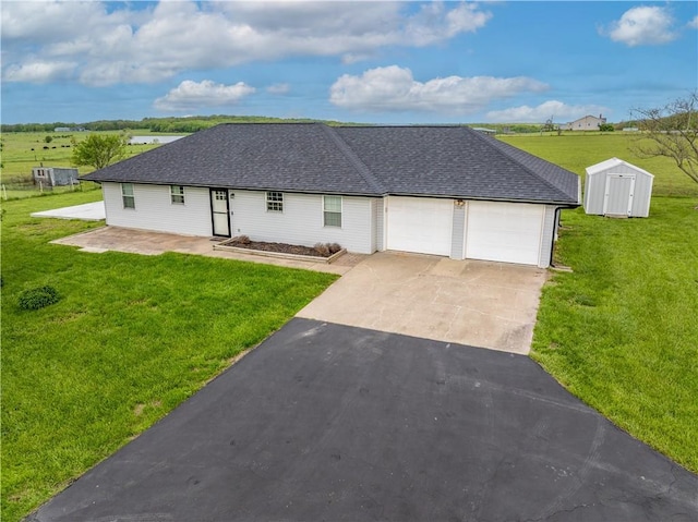 252 SE 23rd Hwy, Knob Noster, MO 65336 - view of front of property featuring a garage, driveway, a storage unit, a front lawn, and roof with shingles