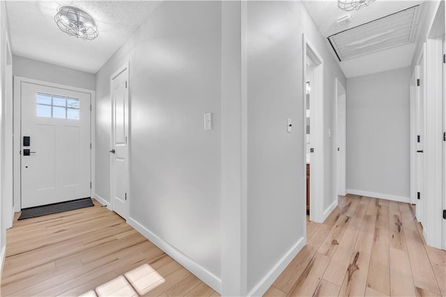 252 SE 23rd Hwy, Knob Noster, MO 65336 - corridor with light wood-style floors, baseboards, and a textured ceiling