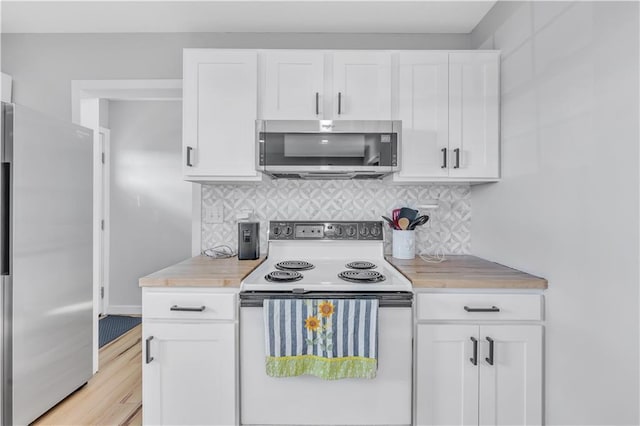 252 SE 23rd Hwy, Knob Noster, MO 65336 - kitchen with stainless steel appliances, light countertops, white cabinetry, and backsplash