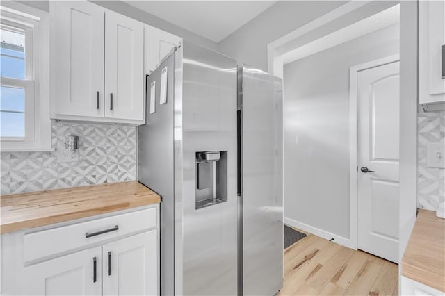 252 SE 23rd Hwy, Knob Noster, MO 65336 - kitchen with wooden counters, stainless steel fridge, light wood finished floors, backsplash, and white cabinets