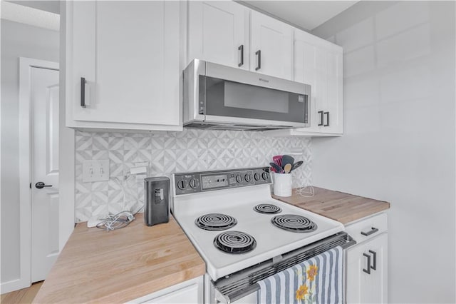 252 SE 23rd Hwy, Knob Noster, MO 65336 - kitchen featuring stainless steel microwave, electric stove, white cabinetry, and backsplash