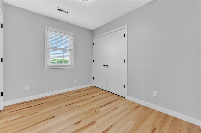 252 SE 23rd Hwy, Knob Noster, MO 65336 - unfurnished bedroom featuring wood finished floors, baseboards, and a closet