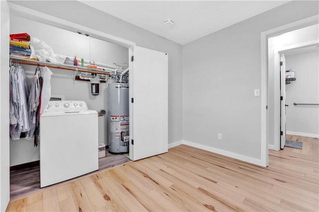 252 SE 23rd Hwy, Knob Noster, MO 65336 - laundry area with washer / dryer, gas water heater, wood finished floors, and baseboards