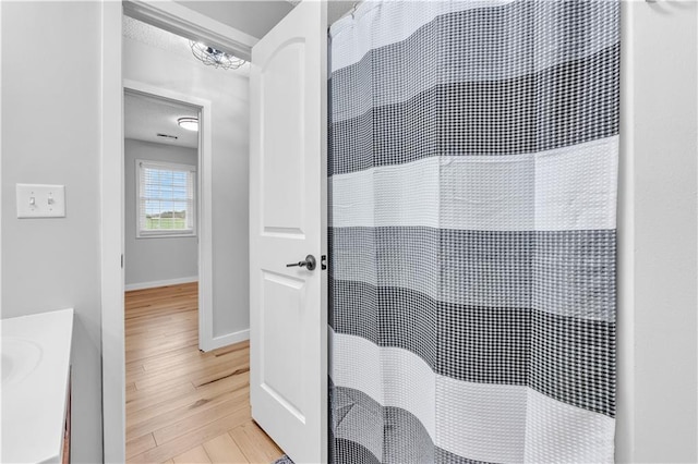 252 SE 23rd Hwy, Knob Noster, MO 65336 - bathroom with wood finished floors, baseboards, a heating unit, and curtained shower